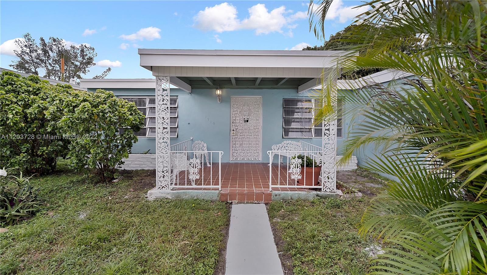 1910 Rutland Street Opa-Locka, FL 33054 - Photo 5 of 26 a front view of a house with a yard