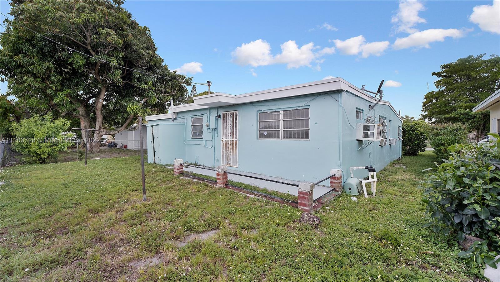 1910 Rutland Street Opa-Locka, FL 33054 - Photo 6 of 26 a front view of a house with a yard and garage