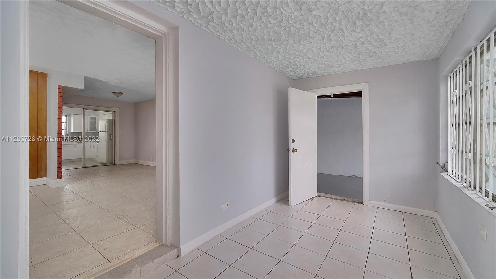 1910 Rutland Street Opa-Locka, FL 33054 - Photo 9 of 26 a view of an empty room and window
