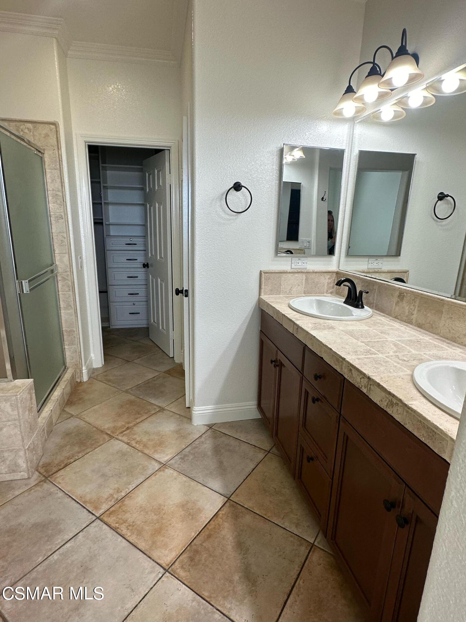 6770 Bountiful Lane Moorpark, CA 93021 - Photo 15 of 17 a spacious bathroom with a double vanity sink and a mirror
