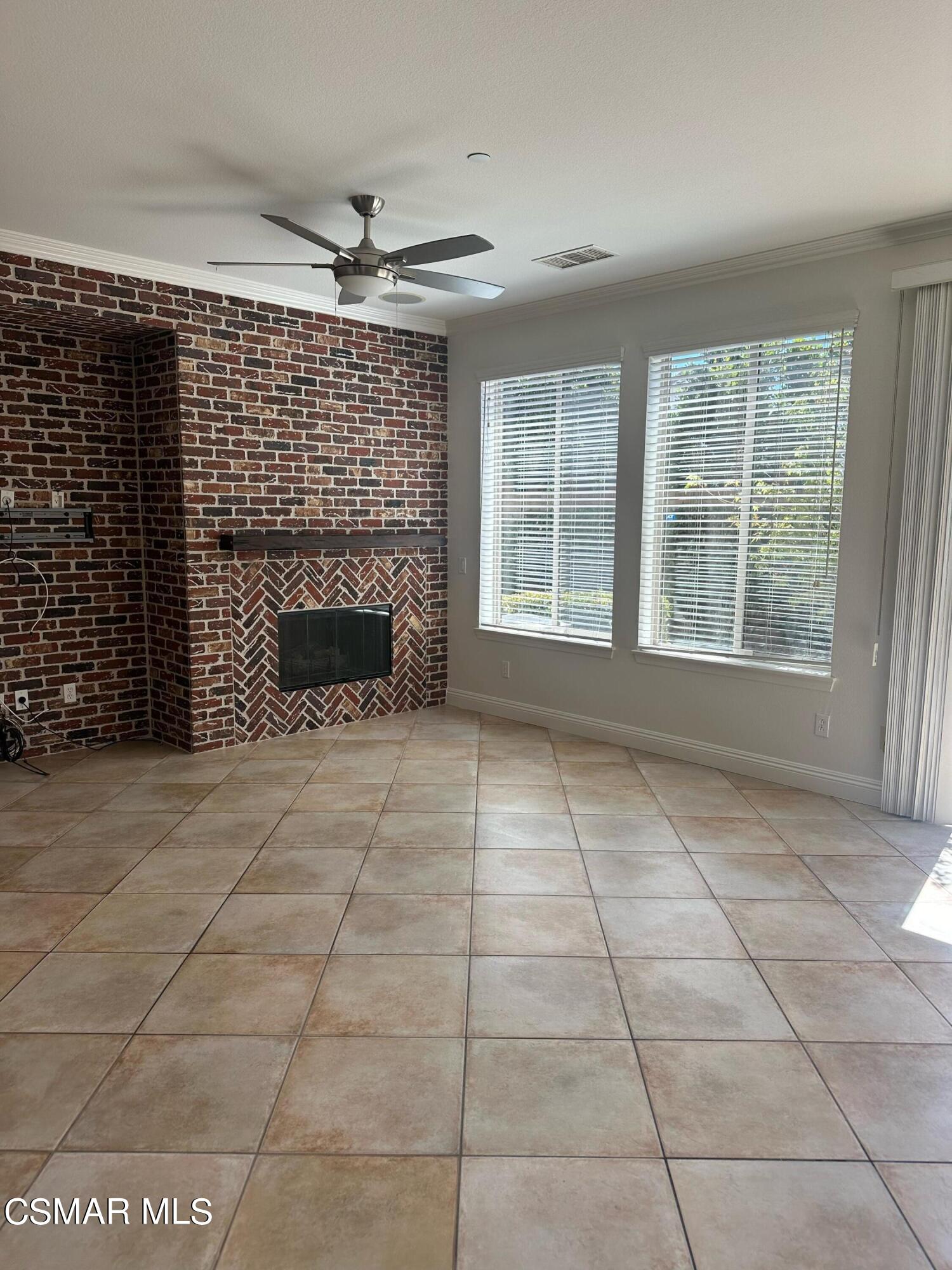 6770 Bountiful Lane Moorpark, CA 93021 - Photo 10 of 17 a view of an empty room with a fireplace and a window