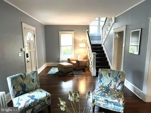a view of entryway and hall with wooden floor