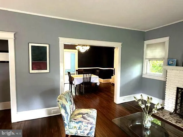 a view of a dining room with furniture wooden floor and chandelier