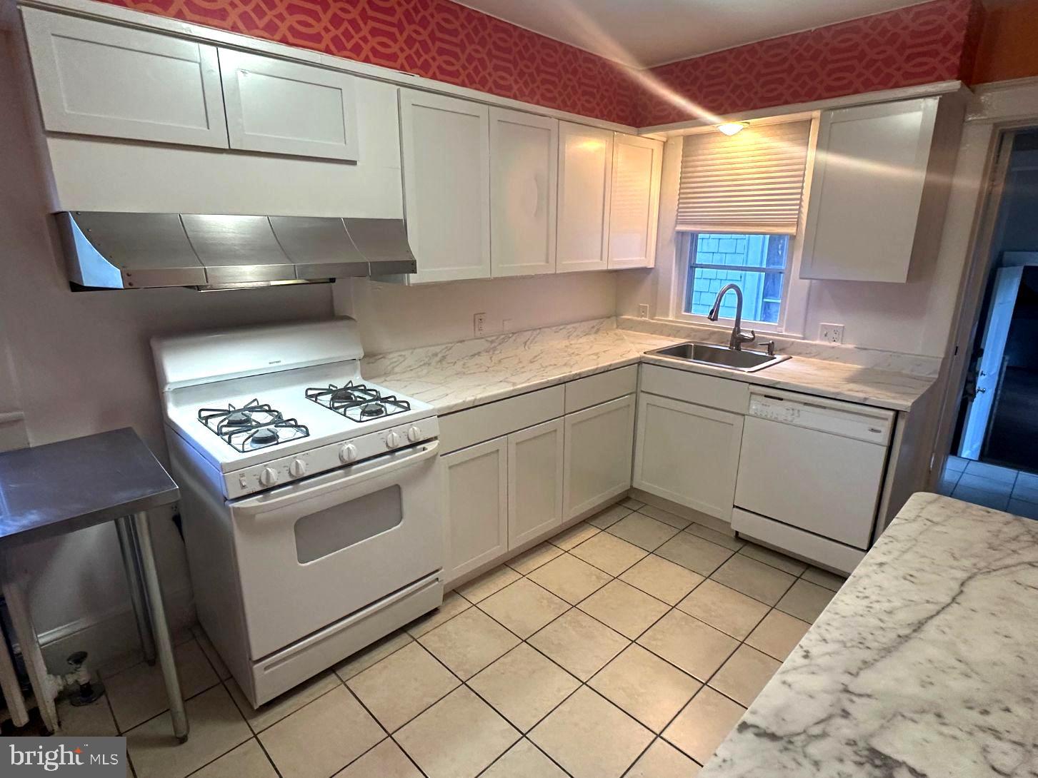 4608 West Virginia Avenue Bethesda, MD 20814 - Photo 32 of 61 a kitchen with stainless steel appliances granite countertop a sink and a stove top oven