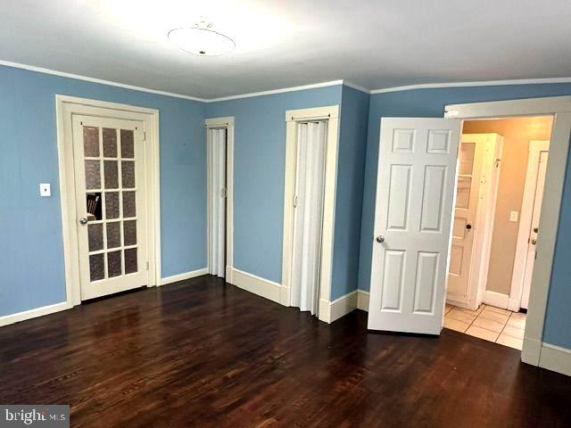 4608 West Virginia Avenue Bethesda, MD 20814 - Photo 39 of 61 an empty room with wooden floor and windows
