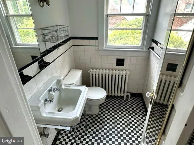 a view of a hallway with wooden floor and a window