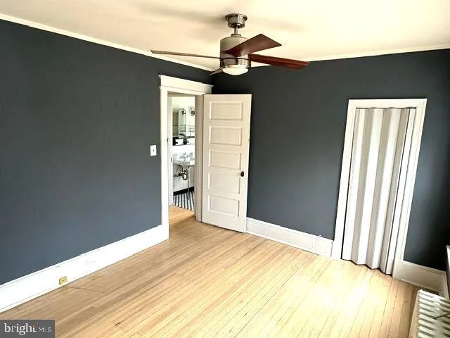 a view of room with window and wooden floor