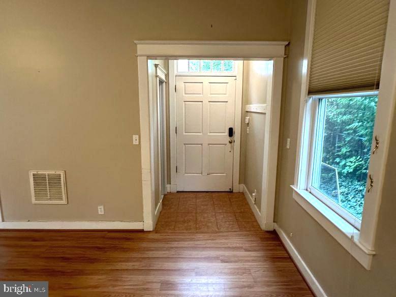 4608 West Virginia Avenue Bethesda, MD 20814 - Photo 59 of 61 a view of a hallway with wooden floor and a window