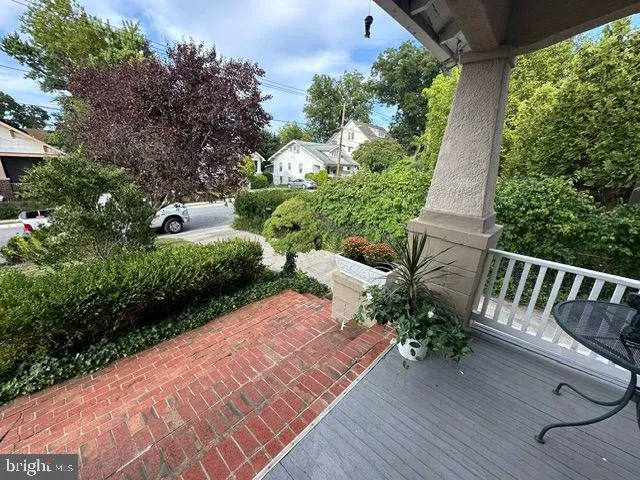 a view of balcony with wooden floor and outdoor seating