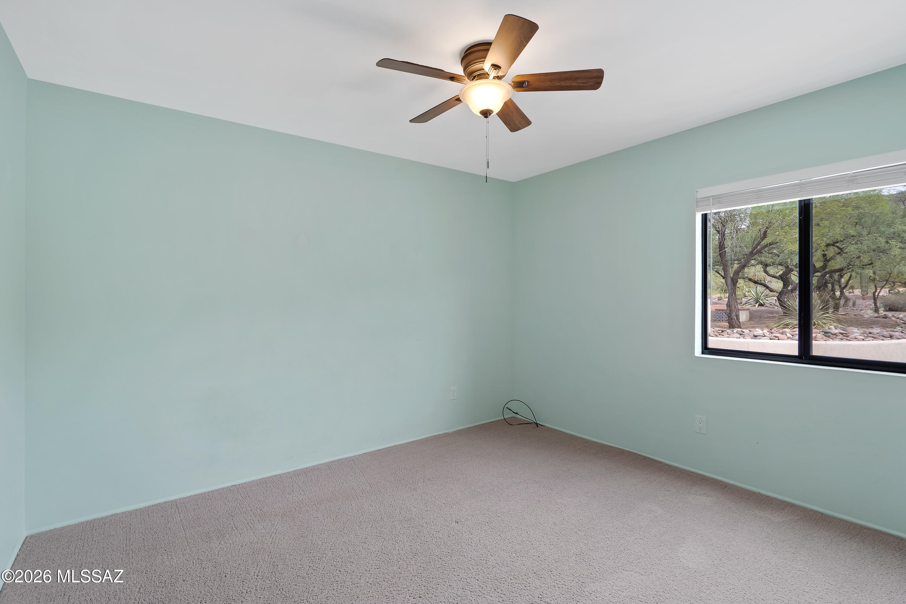 9420 East Ravine Trail Tucson, AZ 85749 - Photo 21 of 39 an empty room with a window and a fan