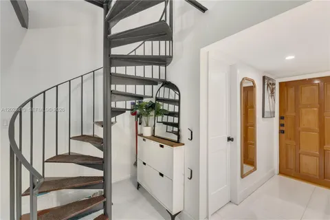 a view of staircase with white walls and railing