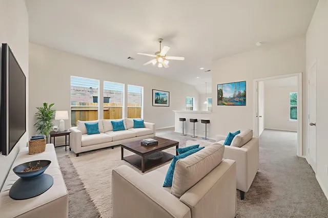 a living room with furniture and a large window