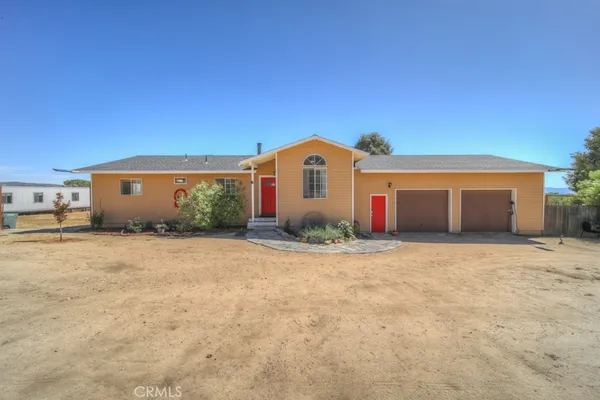 a front view of a house with a yard and a garage