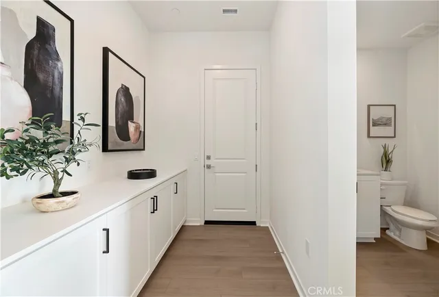 a bedroom with a bed and a painting on the wall