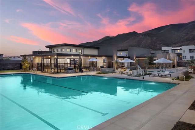 a view of a two couches in the patio and a front view of a house