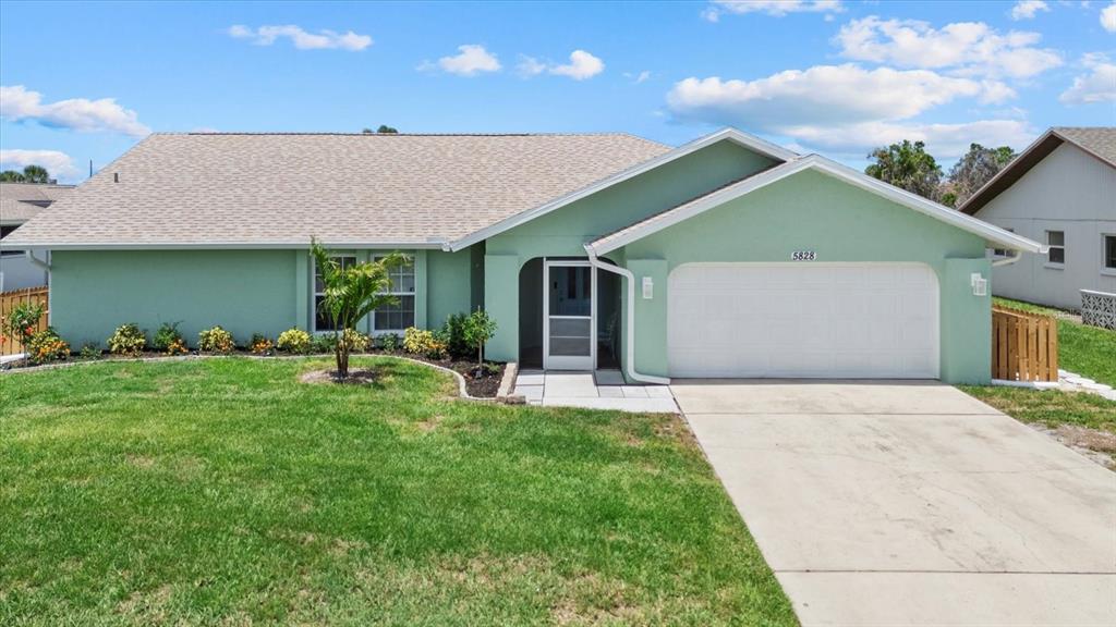 5828 Lincoln Road Venice, FL 34293 - Photo 1 of 1 a front view of a house with a garden and yard