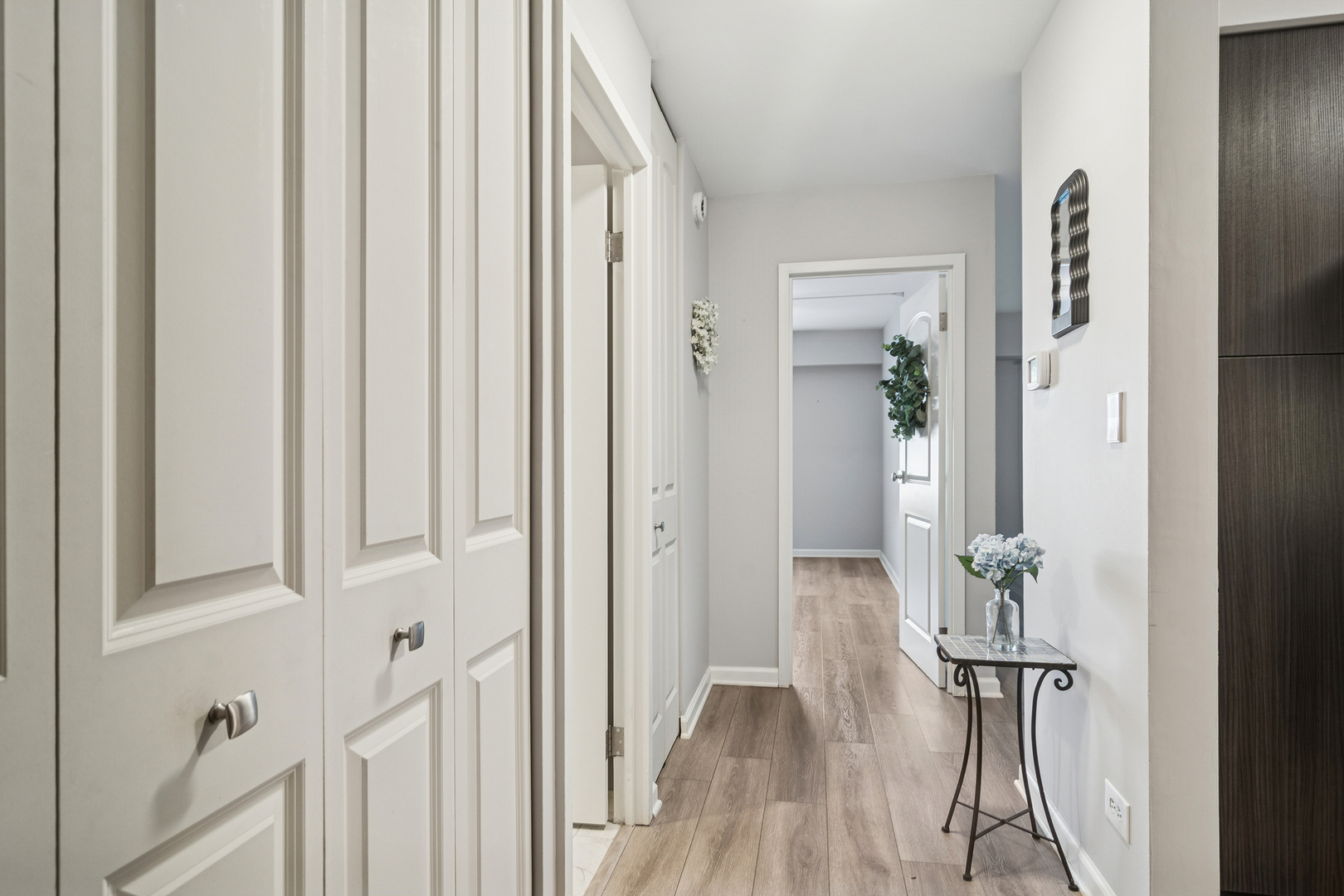 1605 East Central Road, Unit 111B Arlington Heights, IL 60005 - Photo 2 of 26 a view of hallway with wooden floor