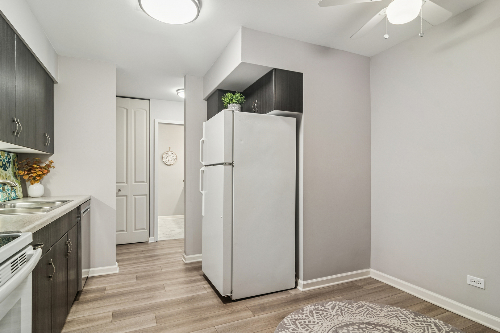1605 East Central Road, Unit 111B Arlington Heights, IL 60005 - Photo 7 of 26 a view of a kitchen with a sink and cabinets