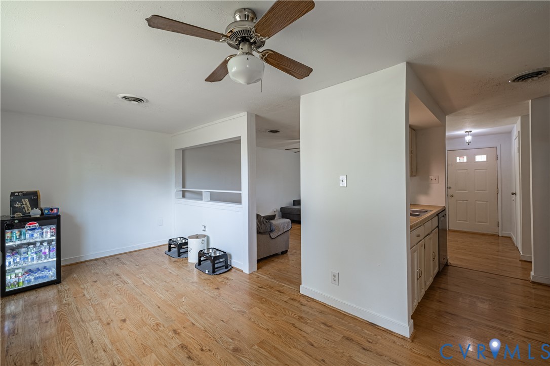 6310 Dahlia Road Mechanicsville, VA 23111 - Photo 15 of 38 a view of a livingroom with a furniture hardwood floor and a ceiling fan