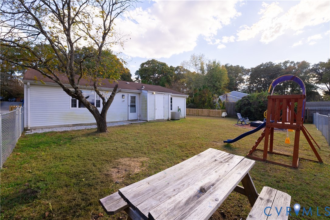 6310 Dahlia Road Mechanicsville, VA 23111 - Photo 24 of 38 a view of a house with a yard