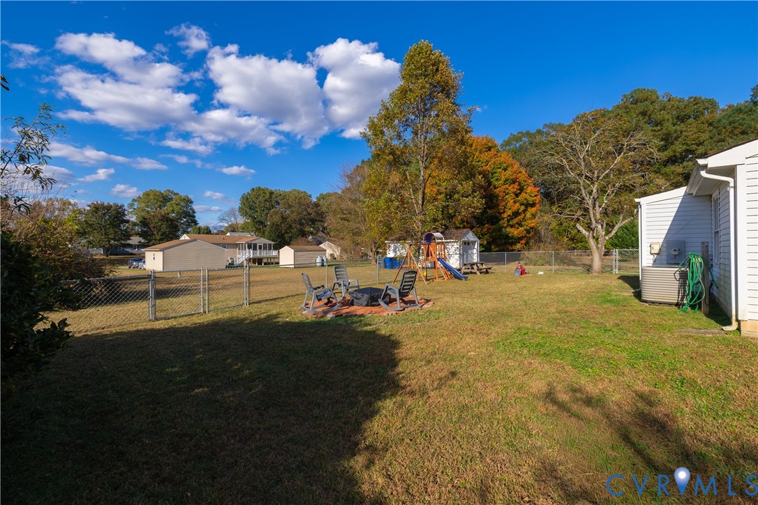 6310 Dahlia Road Mechanicsville, VA 23111 - Photo 27 of 38 a view of yard with swimming pool and green space