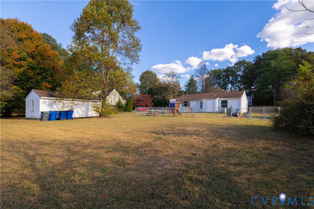 6310 Dahlia Road Mechanicsville, VA 23111 - Photo 30 of 38 a front view of a house with a yard and a large tree