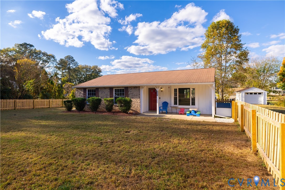 6310 Dahlia Road Mechanicsville, VA 23111 - Photo 3 of 38 a front view of a house with a garden