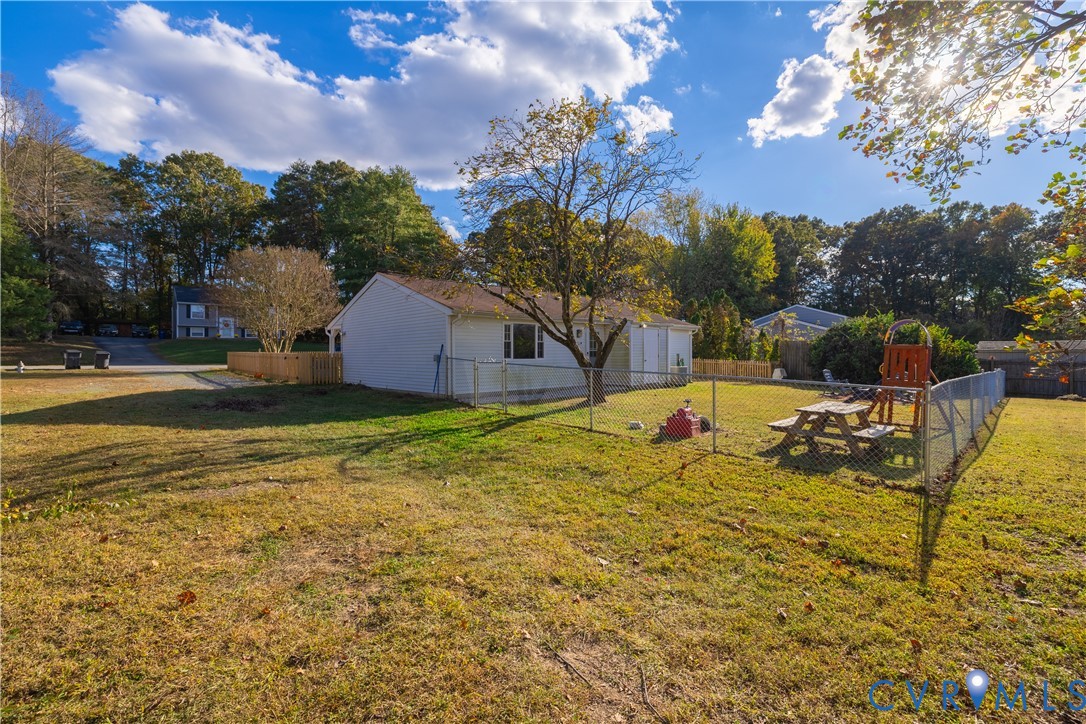 6310 Dahlia Road Mechanicsville, VA 23111 - Photo 33 of 38 a view of a swimming pool with an outdoor seating and a garden