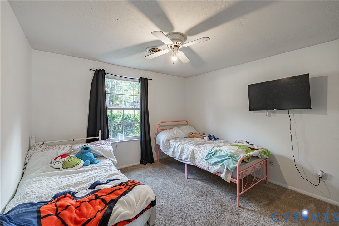 6310 Dahlia Road Mechanicsville, VA 23111 - Photo 6 of 38 a bedroom with a bed and a flat screen tv