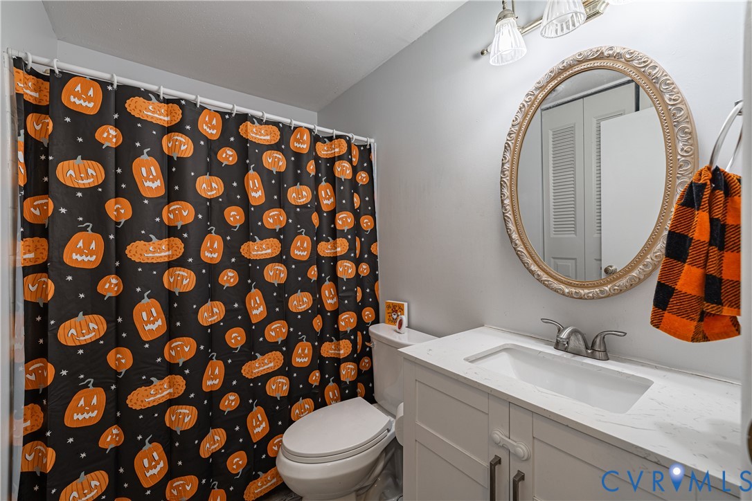 6310 Dahlia Road Mechanicsville, VA 23111 - Photo 8 of 38 a bathroom with a sink a toilet and a mirror