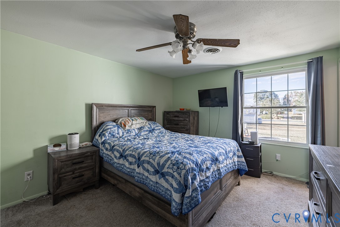 6310 Dahlia Road Mechanicsville, VA 23111 - Photo 9 of 38 a bedroom with a bed and a window