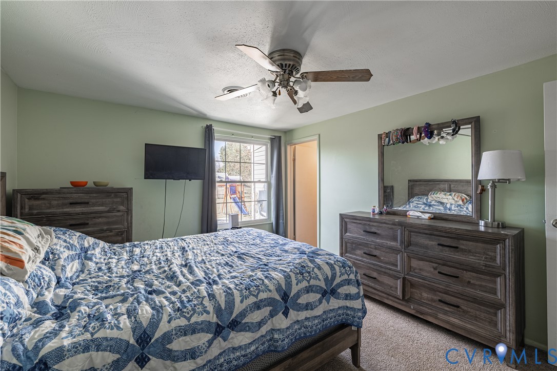 6310 Dahlia Road Mechanicsville, VA 23111 - Photo 10 of 38 a bedroom with a bed and a flat screen tv