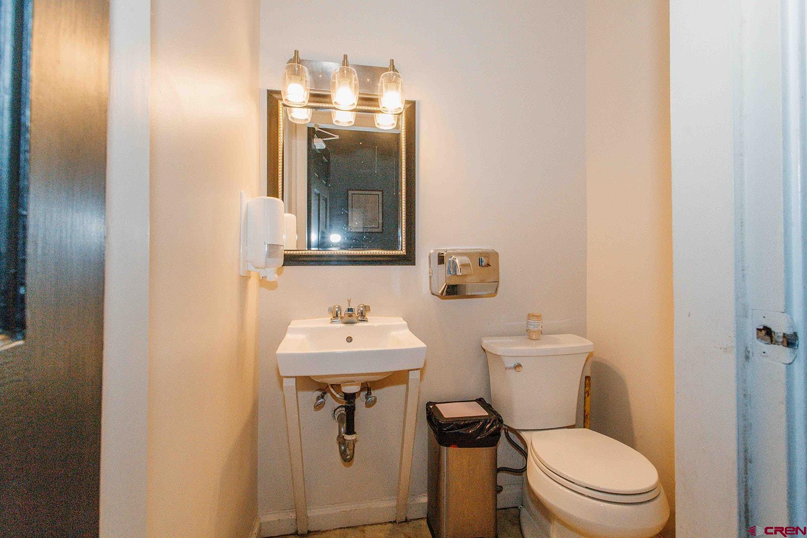 807 Main Street, Unit 3 Ouray, CO 81427 - Photo 12 of 26 a bathroom with a toilet sink and mirror