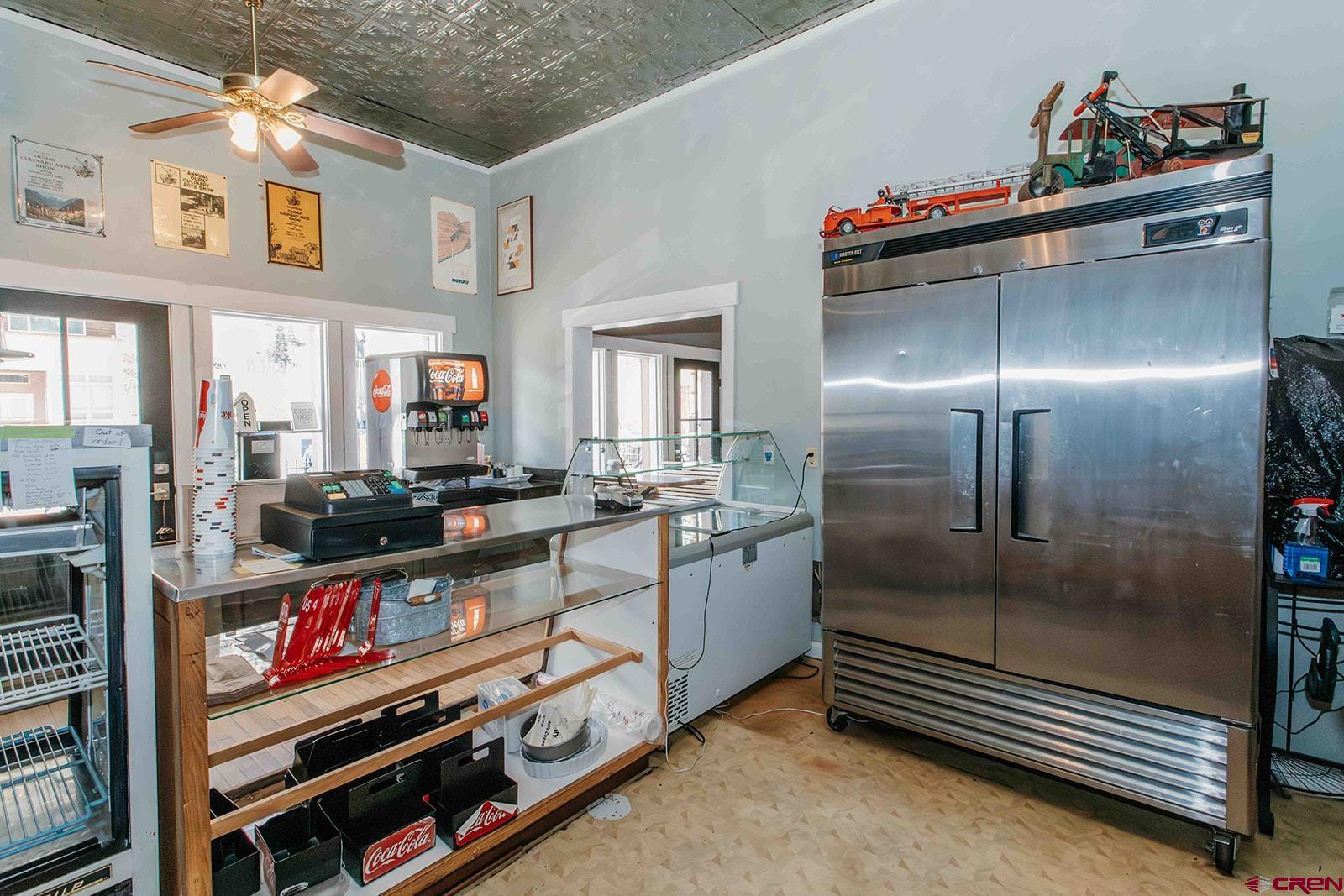 807 Main Street, Unit 3 Ouray, CO 81427 - Photo 21 of 26 a kitchen with stainless steel appliances kitchen island granite countertop a refrigerator and a stove