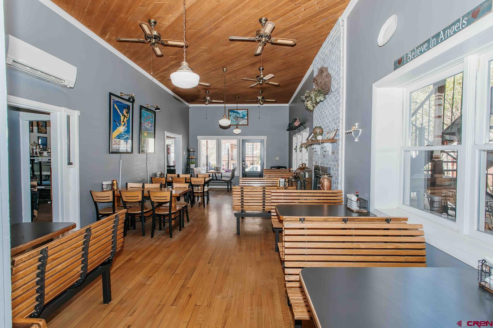 807 Main Street, Unit 3 Ouray, CO 81427 - Photo 6 of 26 a view of a dining room with furniture window and wooden floor