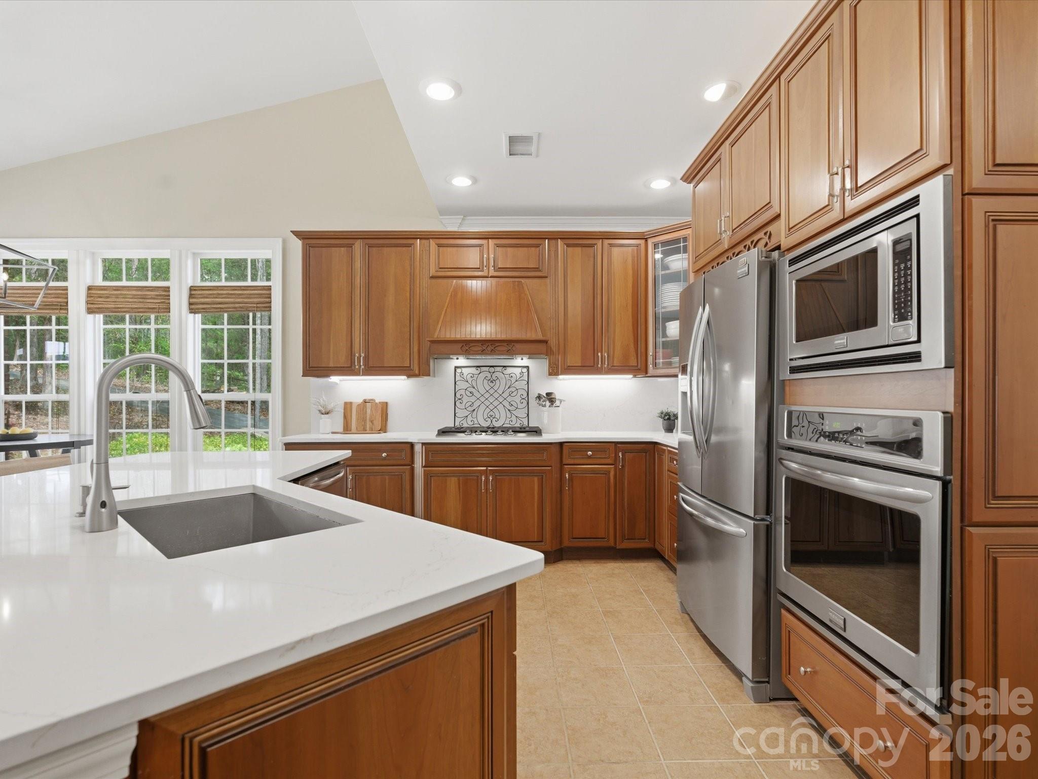809 Savile Lane Fort Mill, SC 29715 - Photo 18 of 48 a kitchen with stainless steel appliances a stove sink and microwave
