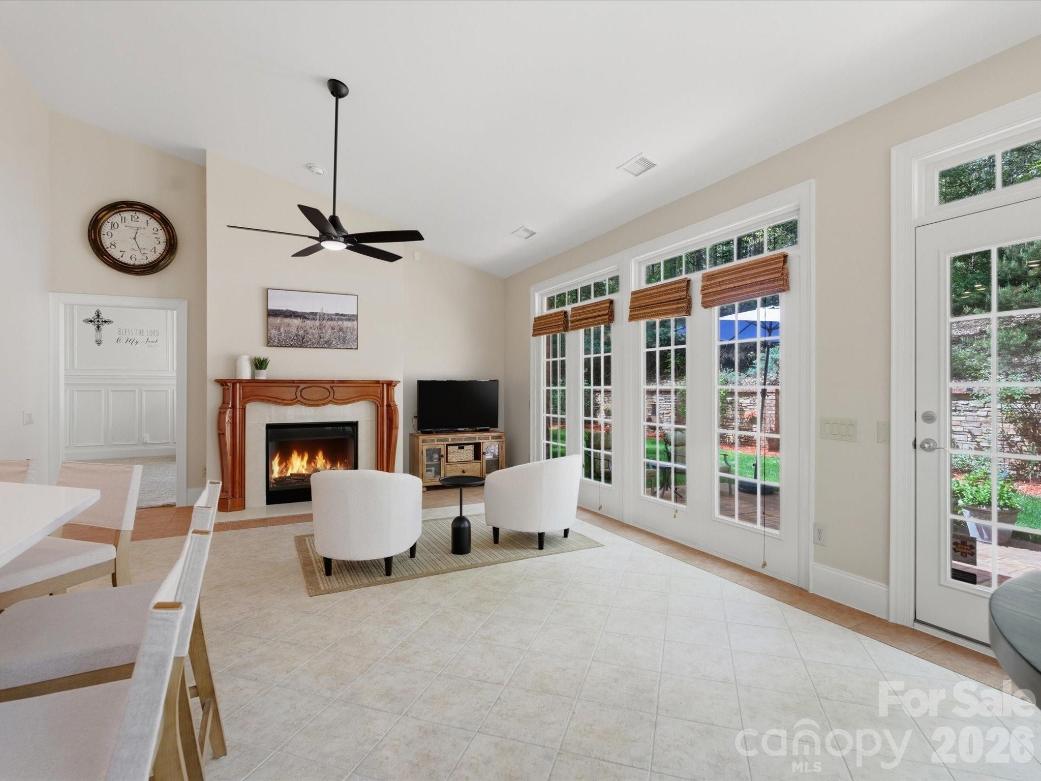 809 Savile Lane Fort Mill, SC 29715 - Photo 21 of 48 a living room with furniture a fireplace and a floor to ceiling window