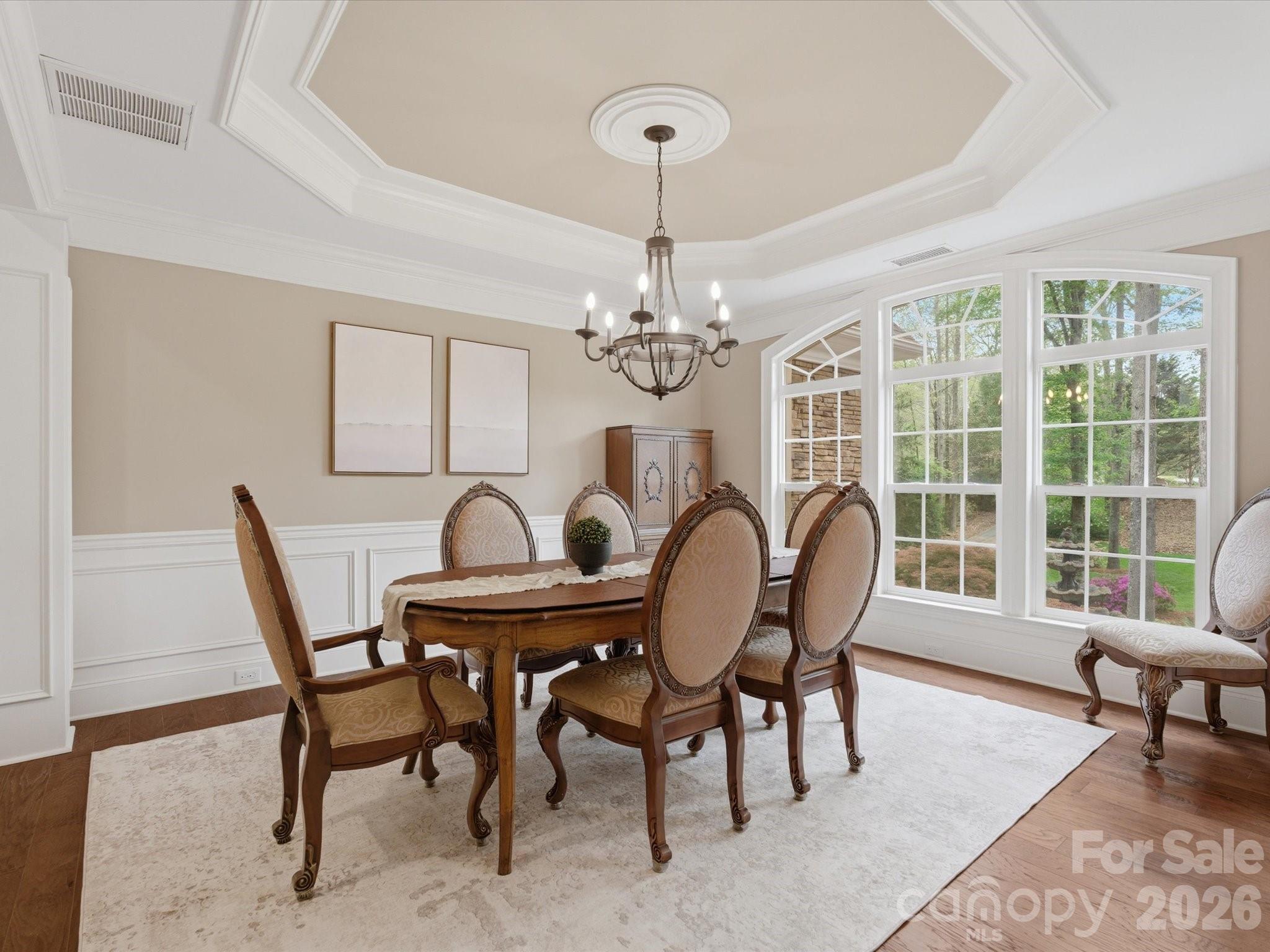809 Savile Lane Fort Mill, SC 29715 - Photo 9 of 48 a view of a dining room with furniture a chandelier and wooden floor