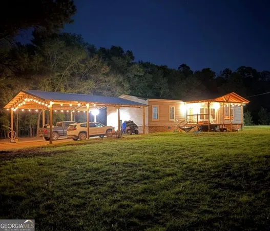 a view of a big yard with table and chairs a barbeque grill and a fire pit