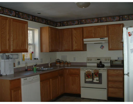 57 Crouch Road Warren, MA 01092 - Photo 3 of 10 a kitchen with a sink a stove and cabinets