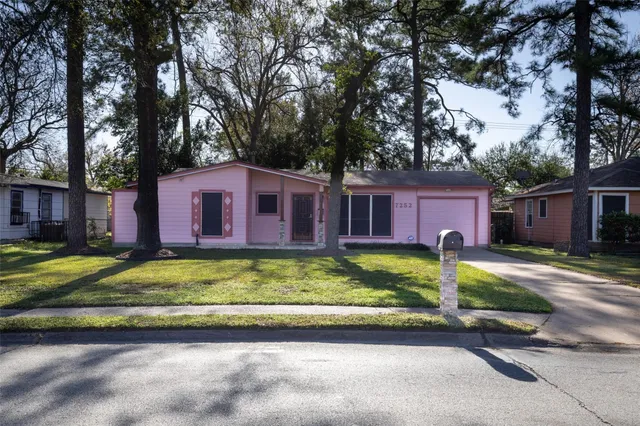 a view of a house with a yard covered in front of it