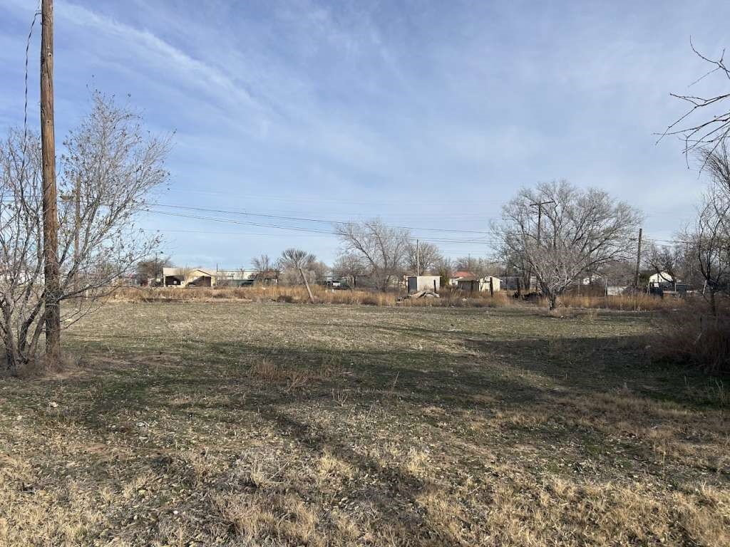 1001 East 14th Street Littlefield, TX 79339 - Photo 8 of 9 a view of dirt field with large trees