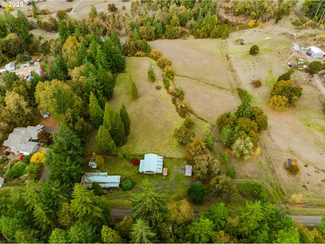 an aerial view of residential houses with yard