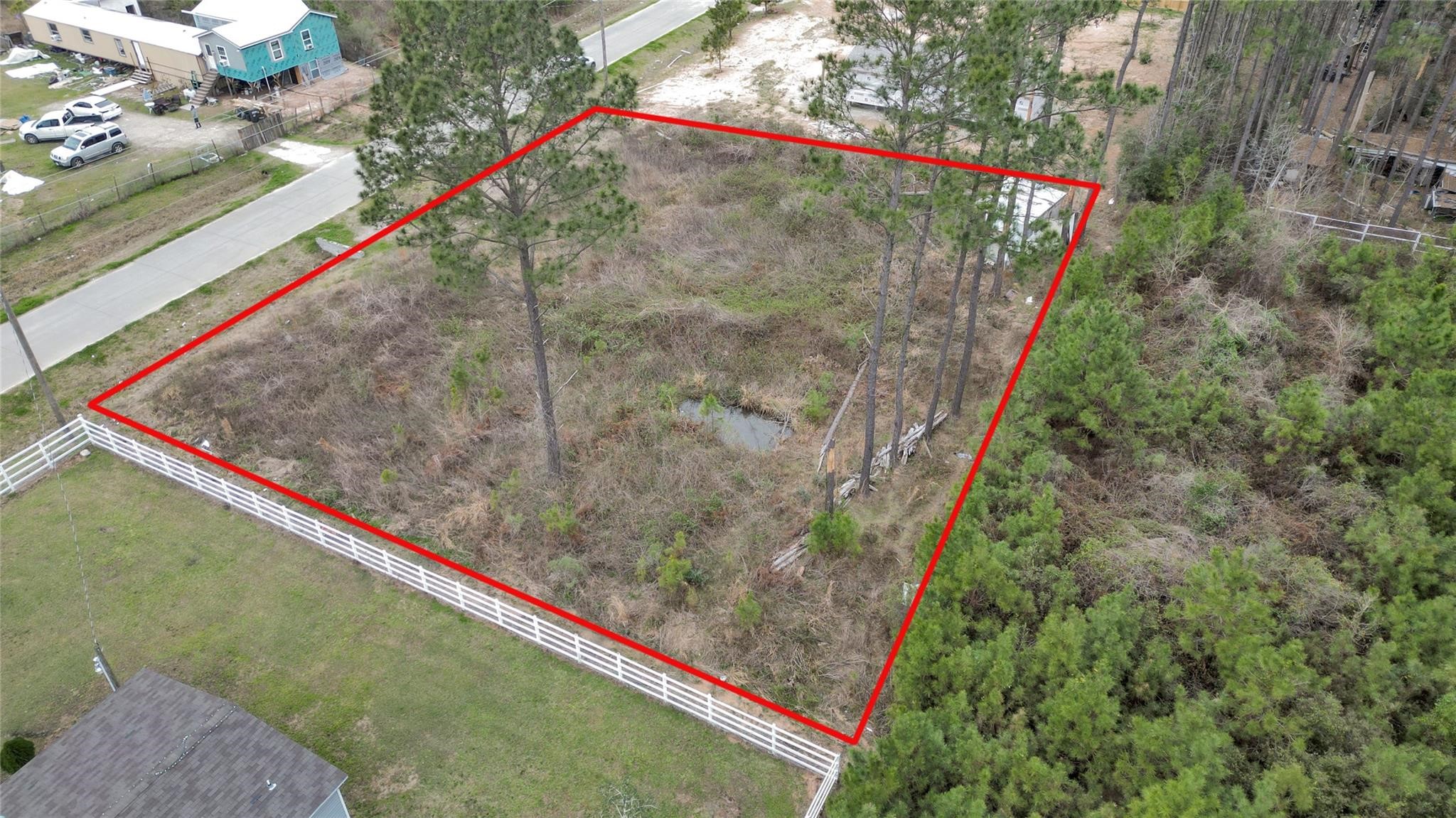 296 County Road 377 Cleveland, TX 77327 - Photo 5 of 10 a view of a backyard