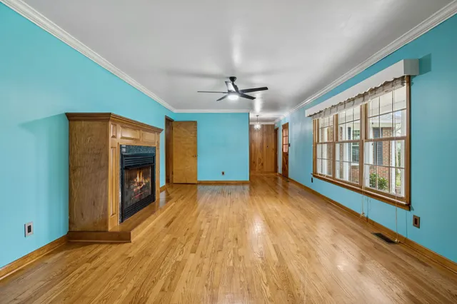 a kitchen with kitchen island granite countertop stainless steel appliances and wooden cabinets