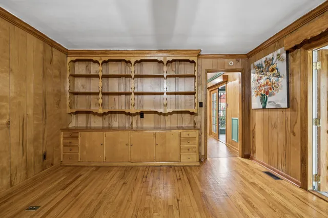 a kitchen with granite countertop wooden floors and white cabinets