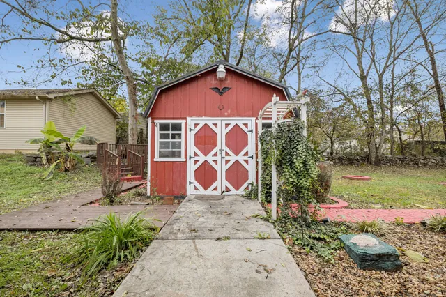 a view of a house with backyard sitting area and garden