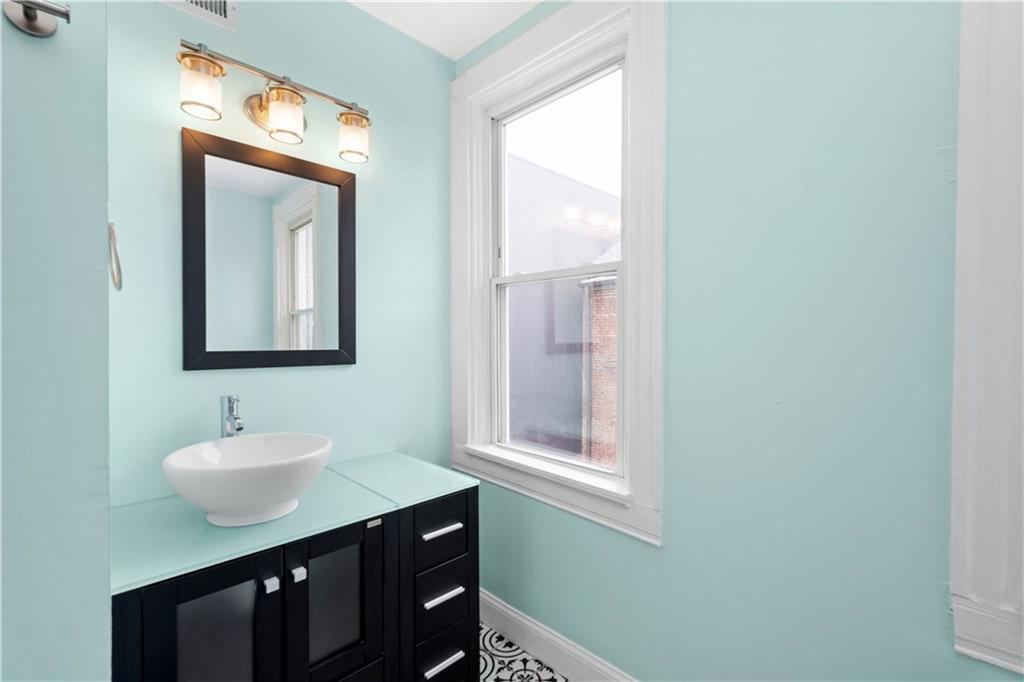 162 Locarna Way Pittsburgh, PA 15201 - Photo 12 of 25 a bathroom with a sink a mirror and a window