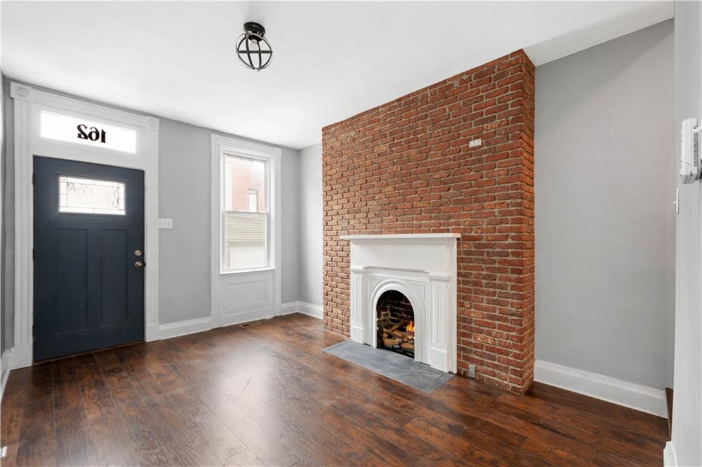 162 Locarna Way Pittsburgh, PA 15201 - Photo 14 of 25 a view of an empty room with wooden floor and a fireplace