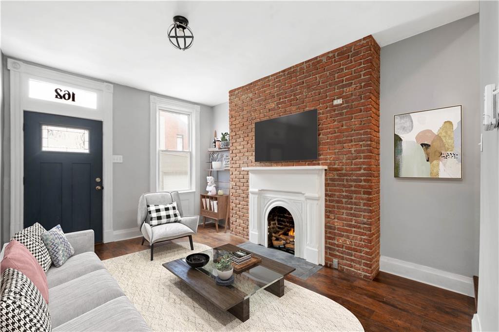 162 Locarna Way Pittsburgh, PA 15201 - Photo 2 of 25 a living room with furniture a fireplace and a flat screen tv